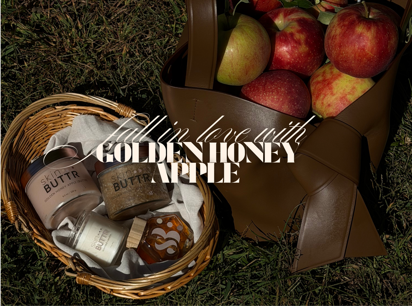Basket of Buttr products with a box of apples on grass, text overlay 'Fall in love with Golden Honey Apple'.